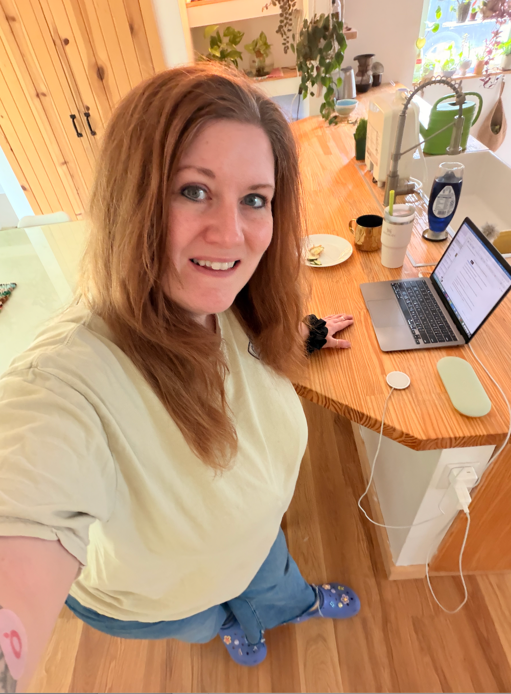 Sara Love at her laptop in the kitchen